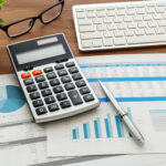 Financial accounting with calculator and financial chart  data and computer keyboard