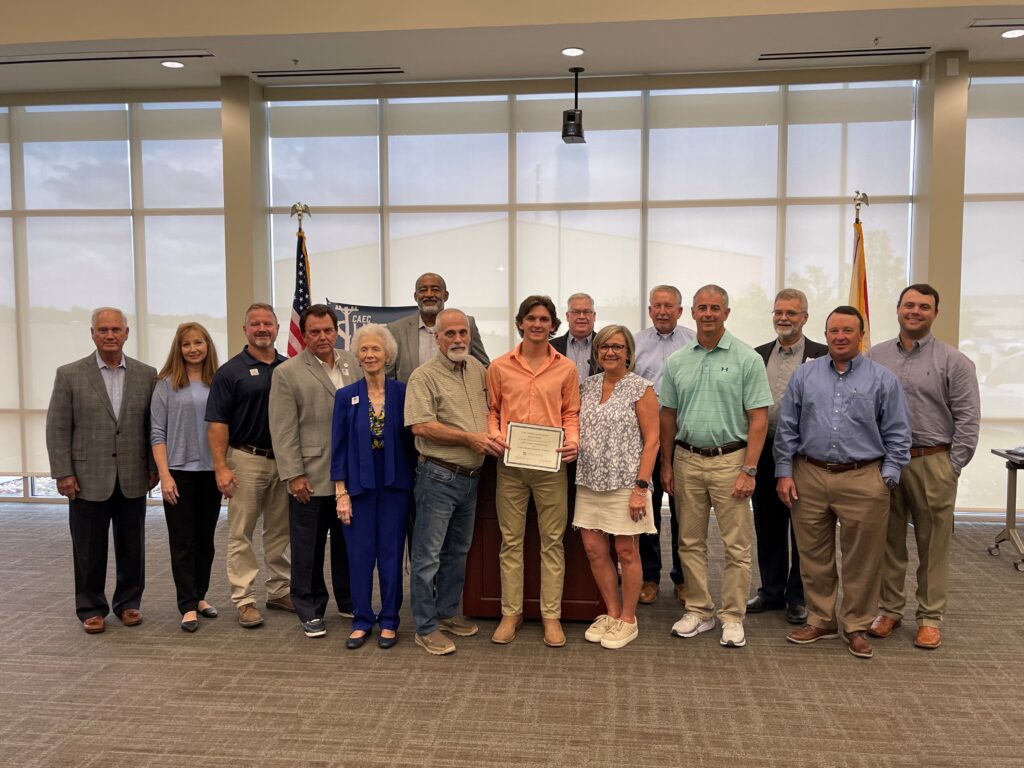 Katon Elijah (center) and his family attended a small ceremony where CAEC's Board of trustees, President and CEO Tom Stackhouse and other CAEC employees recognized his scholarship award. 